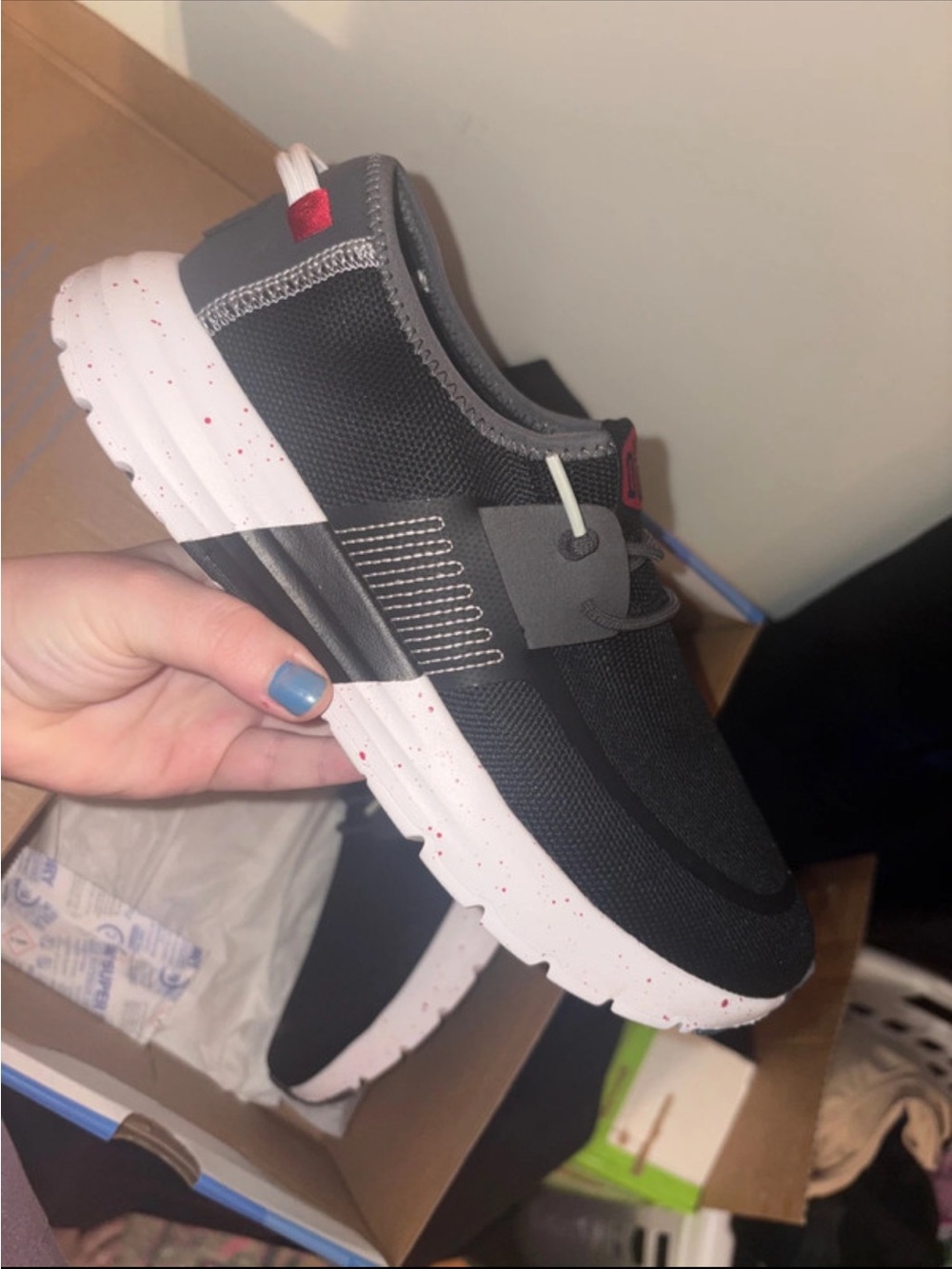 Hey Dude Black Slip-On Sneakers with White Speckled Sole and Red Accents